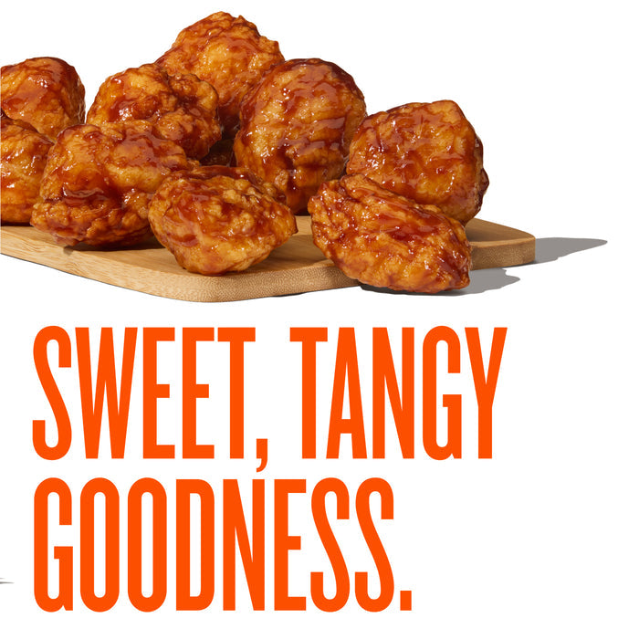 Whatawings on a wooden board with 'Sweet, Tangy Goodness' text.