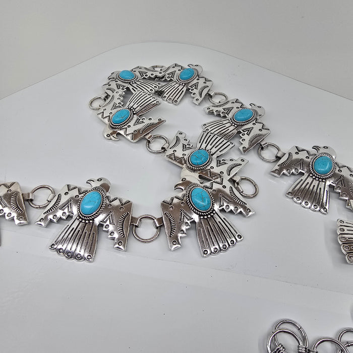 Silver bracelet with turquoise stones on a white background