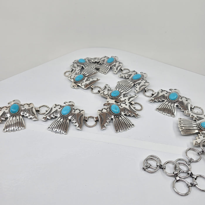 Silver bracelet with turquoise stones on a white background